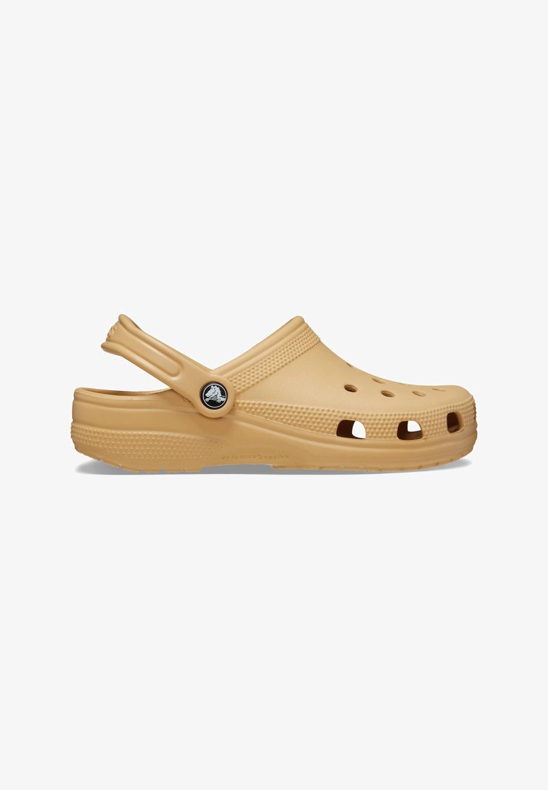 Light brown clogs made of lightweight material, featuring ventilation holes, a back strap, and a textured sole for grip.