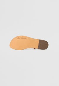 Rudas batų padas su lygiomis ir tekstūruotomis dalimis. Yra šviesiai rudos odos pagrindas, baltas siūlas ir užrašas „Sam Edelman“. 