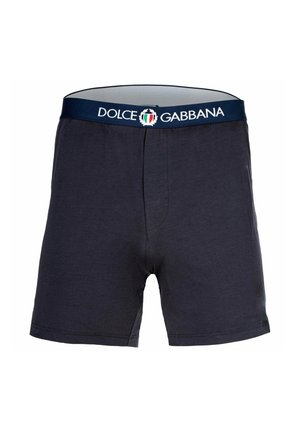 Bomullsboxer i mörk marinblå med elastisk midja som har "Dolce & Gabbana"-logotyp och italiensk flagga. Slät textur.