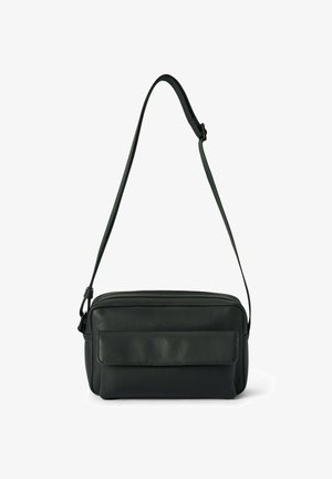 Black leather crossbody bag with a zipper closure, flat front pocket, adjustable strap, and smooth texture. Compact rectangular shape.