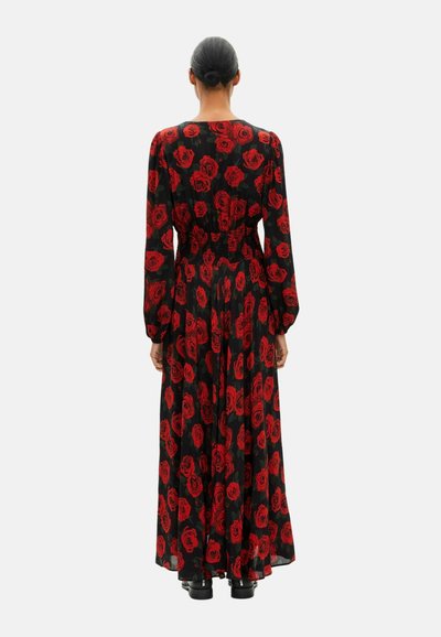 Long black dress with red rose pattern, gathered waist, long sleeves, and flowing skirt. Smooth fabric, ankle-length design, and modest back.
