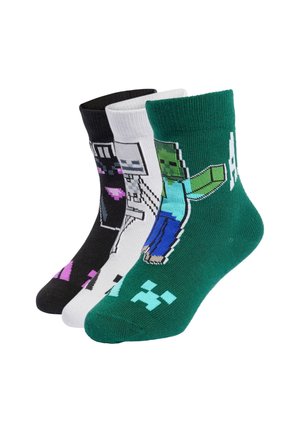 Tre calzini colorati con personaggi pixel art di Minecraft nei colori nero, bianco e verde disposti affiancati.