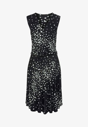 Schwarzes ärmelloses Kleid mit V-Ausschnitt und weißem Punktmuster. Mit Bindeband in der Taille, fließendem Rock mit ausgestellter Silhouette. Glatte Textur.