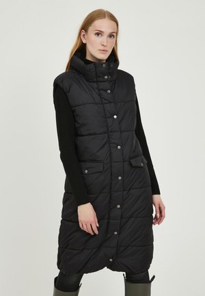 Gilet matelassé noir avec un col montant, des boutons-pression et deux poches avant. Présente un design matelassé et arrive aux genoux.