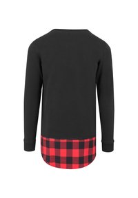 Chemise noire à manches longues avec un ourlet inférieur en tartan rouge et noir. Fabriquée en tissu doux, avec un dos arrondi et des poignets côtelés.
