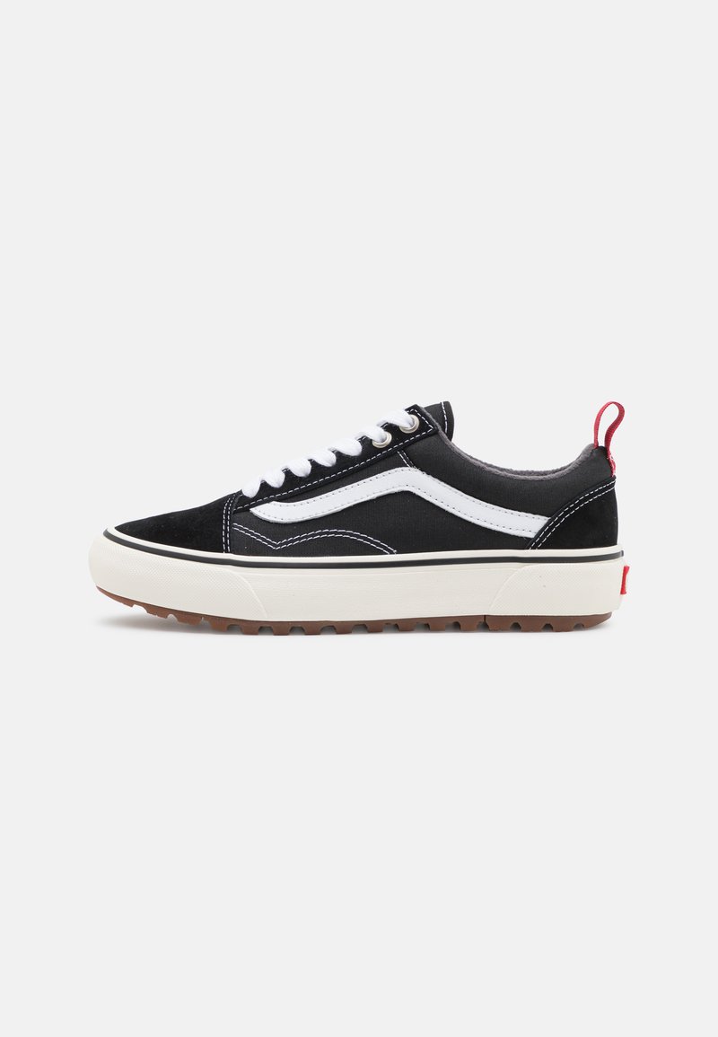 Svart kanvas sneakers med hvit sidestripe, gummisåle og rød hælflik. Har fremtredende snøring og polstret krage for komfort.