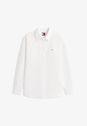 Valge pikkade varrukatega nööbitav särk kraega, millel on vasakul rinnal väike Tommy Hilfigeri logo ja siseküljel silt.