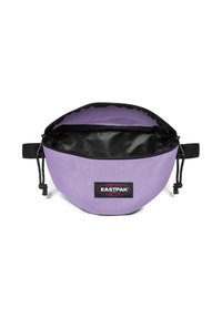 Borsa tonda viola realizzata in tessuto resistente con interno nero, chiusura a cordoncino regolabile e patch logo Eastpak ben visibile.