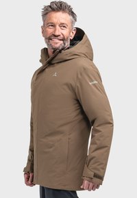 Brown waterproof jacket with a hood, upright collar, side pockets, and adjustable cuffs. Features stitching accents and a logo on the shoulder.