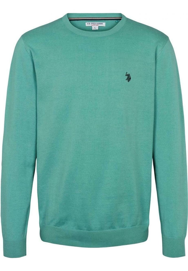 Turkos bomullströja med rund halsringning och ribbad mudd och fåll. Har en liten svart logotyp på vänster bröst. Slät textur.