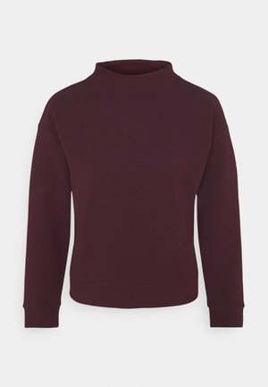 Pull texturé violet foncé à manches longues avec un col rond haut et des poignets côtelés sur fond blanc.