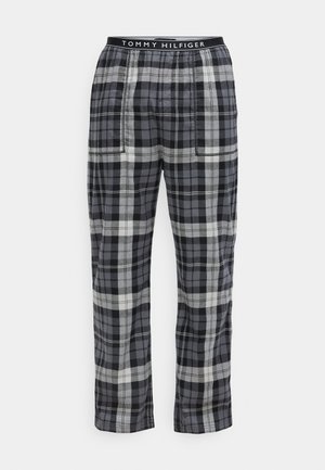 Rutete bukser i svart, grått og hvitt, med elastisk midje med "TOMMY HILFIGER" logo, rett passform og sidelommer.