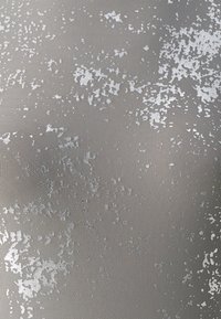 Light gray textured fabric featuring a subtle, irregular white pattern resembling splashes or stains, creating a visually dynamic surface.