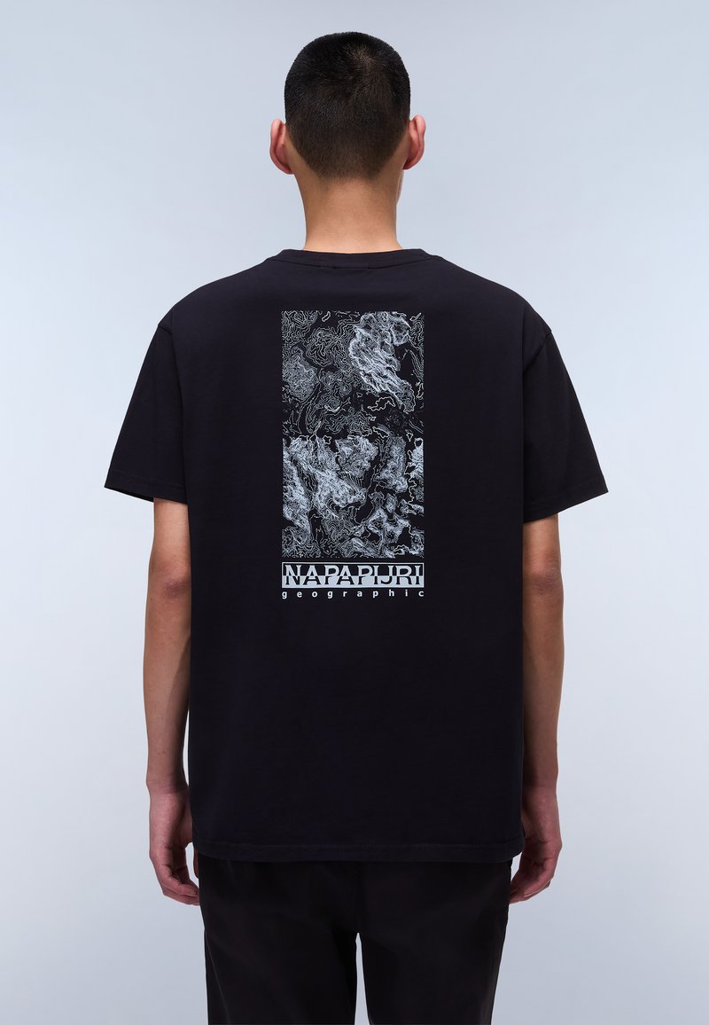 Black cotton t-shirt featuring a detailed white graphic on the back, including a logo and abstract line patterns. Short sleeves and relaxed fit.