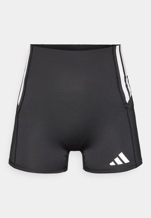 Pantalones cortos deportivos negros con un diseño ajustado, hechos de un material suave. Presentan rayas blancas en los costados y un logo de Adidas en la parte inferior frontal.