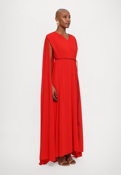 Red, flowing dress with a V-neck and cape sleeves, cinched at the waist with a matching tie. Soft fabric, ankle-length, minimal detailing.