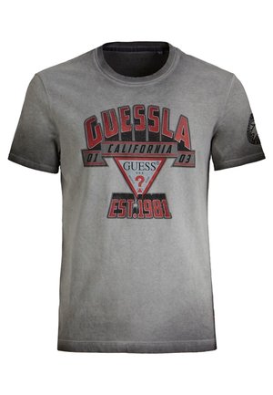 Gray short-sleeve T-shirt with "GUESSLA California 01 03" and "EST. 1981" in red and black text, featuring Guess logo triangle in center.