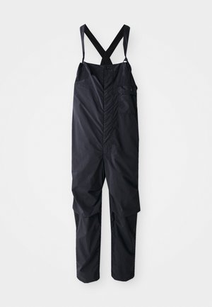 Schwarze wasserdichte Latzhose mit verstellbaren Trägern, Knopfverschluss vorne und einer Seitentasche. Hergestellt aus leichtem, glattem Material.