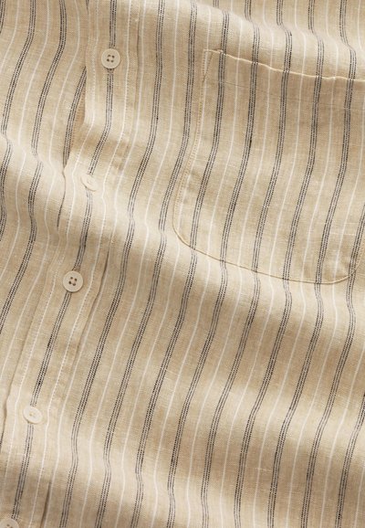 Beige linen shirt with thin vertical black and white stripes, cream buttons, and a chest pocket on the right side.