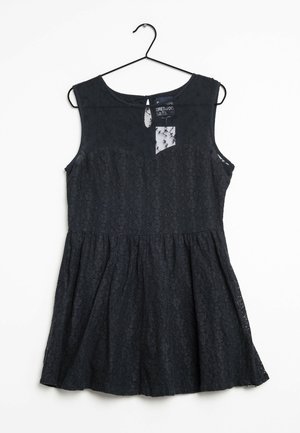 Schwarzes ärmelloses Kleid mit Spitzenakzenten, tailliertem Oberteil und schwingendem Rock. Schlüssel-Öffnung am Rücken und ein transparenter Einsatz vorne.