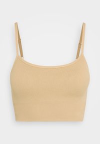 Beige ribbad crop-top med tunna justerbara band och en sömlös design. Mjuk textur som sitter tätt runt kroppen.