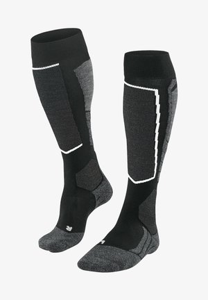Calze lunghe nere e grigie realizzate in tessuto misto, con una soletta imbottita, bordino a coste e accenti riflettenti in un motivo geometrico.