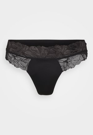 Zwart thongondergoed met een bloemenkant tailleband. De stof is glad met een doorzichtige kantstructuur langs de randen en details.