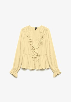 Blouse beige à manches longues avec tissu plissé, encolure en V à volants et poignets, et détail de taille à cordon.
