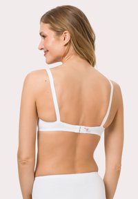 White cotton bra with thin straps, a smooth texture, and a hook-and-eye closure at the back, featuring a small logo tag.