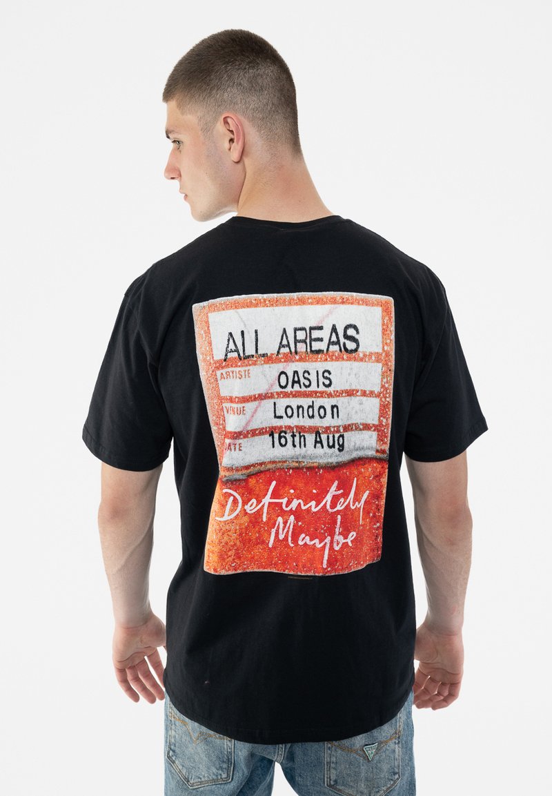 Black cotton t-shirt featuring a graphic on the back resembling a concert pass with the text "ALL AREAS," "OASIS," and "Definitely Maybe."