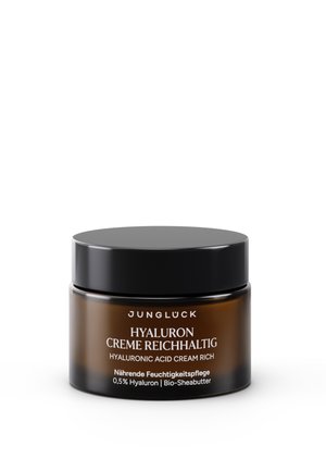 Bernsteinfarbenes Glas mit schwarzem Deckel, beschriftet mit Jungluck Hyaluronsäurecreme Rich mit 0,5 % Hyaluron und biologischer Sheabutter zur feuchtigkeitsspendenden Pflege.