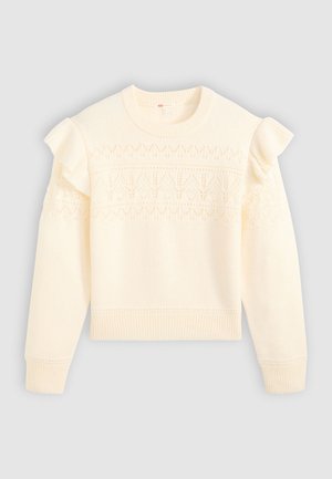 Creme striktrøje med rund halsudskæring, dekorative flæseærmer og hulmønstre langs brystet og skuldrene.