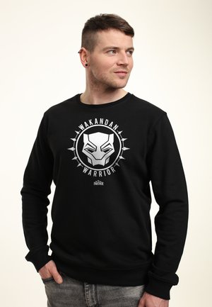 Černá mikina s grafickým designem stylizované masky Černého pantera a textem "Wakandský válečník". Klasický kulatý výstřih a žebrované manžety.