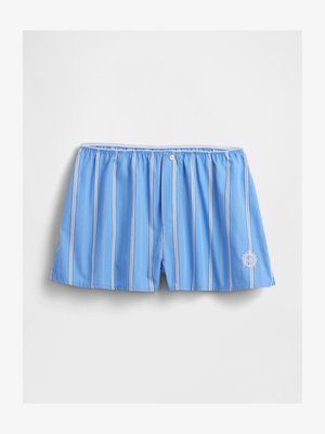 Zila svītraina peldkostīmu šorti, kas izgatavoti no viegla auduma, ar elastīgu jostu, pogu detaļu un izbrodētu logotipu kreisajā apakšējā stūrī.