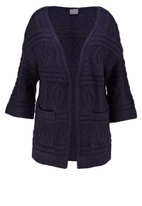 Mörkblå stickad cardigan med öppen framsida, korta ärmar, texturerade mönster och två framfickor. Detaljerat stickarbete genom hela tyget.
