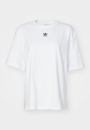 Bijela kratka majica s kratkim rukavima izrađena od pamuka. Ima okrugli izrez i mali crni Adidas logo na prsima. Ravni rub.