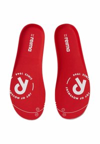 Sovrasuole rosse con una texture liscia, con marchio bianco e motivi circolari. La taglia 33 è ben visibile nella parte superiore.