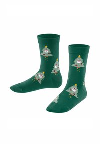 Grüne Socken mit einem sich wiederholenden Weihnachtsbaumdesign, das Gesichtszüge, Ornamente und Sterne zeigt. Hergestellt aus weichem, dehnbarem Material.