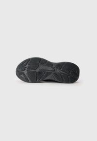 Black sneaker outsole with textured rubber surface, featuring a patterns of grooves and ridges for traction. Smooth edges and rounded heel.