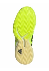 Suola della scarpa di un giallo brillante con un motivo a zigzag, caratterizzata da un accento nero e un logo distintivo nell'area del tallone, testurizzata per la presa.