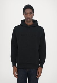 Black hoodie made of soft fabric, featuring a front kangaroo pocket and embossed "QUARTZ CO" logo on the chest, with ribbed hem and cuffs.