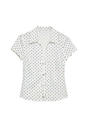 Blouse blanche à manches courtes avec pois noirs, col et fermetures décoratives à boutons noués sur le devant.