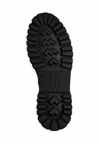 Semelle de chaussure noire en caoutchouc avec des rainures profondes et un motif en zigzag. Présente des bords arrondis et un détail logo embossé central. Taille 37 indiquée.