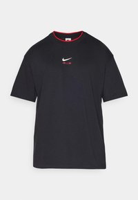 Black short-sleeve Nike t-shirt with red collar trim, white swoosh logo, and red "AIR" text on front center.