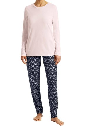 Light pink long-sleeve top paired with navy pajama pants featuring a white floral pattern, made from soft cotton-like material.