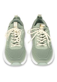 Light green sneakers with textured fabric upper, white rubber soles, and cream laces, featuring a metallic accent tab on the heel.
