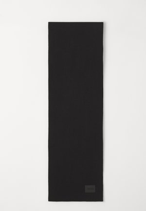 Black scarf made of soft fabric, rectangular shape, with a textured surface. Features a small logo patch on one end.