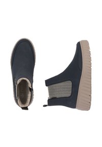 Bottes chelsea navy avec une tige lisse, des panneaux latéraux élastiques et une semelle beige texturée. Doublées de matériau doux et dotées d'une ancre à l'arrière.