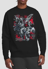 Black sweatshirt with graphic print featuring Transformers characters, bold red and gray designs, and distinct logo text at the bottom.