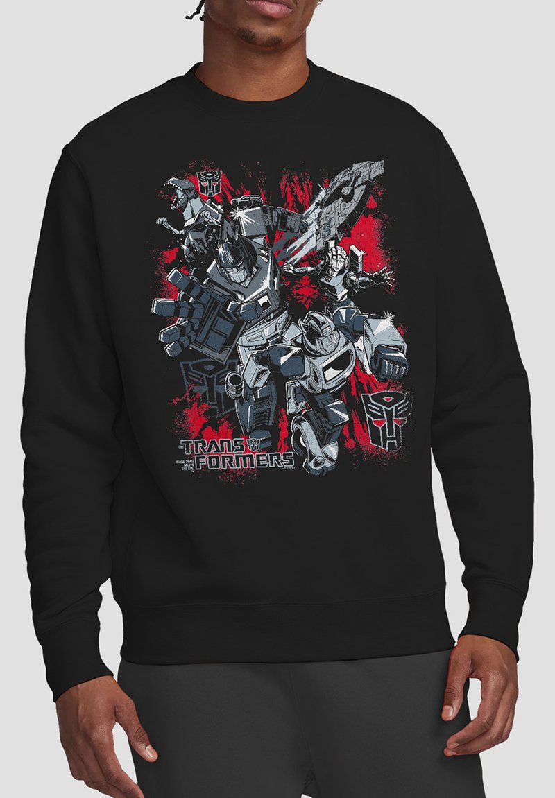 Black sweatshirt with graphic print featuring Transformers characters, bold red and gray designs, and distinct logo text at the bottom.